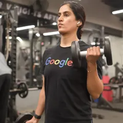 A client performs dumbbell bicep curls, a classic exercise for building arm strength and muscle definition.