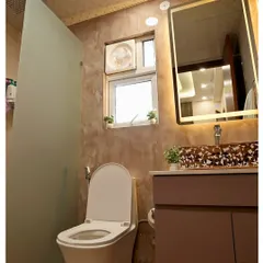 A bathroom with rustic-textured walls and a patterned vessel sink that acts as a centerpiece. The large backlit mirror provides excellent, flattering light.