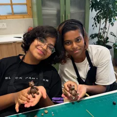 Teamwork makes the dream work! These two talented bakers are showing off the cute little fondant bears they sculpted during our kids' workshop. It's amazing to see their creativity come to life.