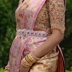 The complete bridal silhouette. This view showcases the beautiful drape of the silk saree, the intricate blouse work, and how a well chosen diamond belt can accentuate the waist and complete the look.