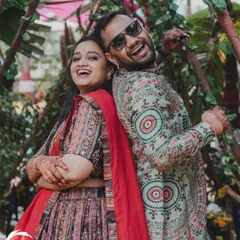 The joy of a Mehendi ceremony, perfectly framed by the rustic, leafy decor I designed. It's all about creating spaces where couples can be themselves and have fun.