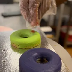 A behind-the-scenes look at decorating my Holi Dognuts. Each one is carefully handcrafted to bring festive cheer to your pup.