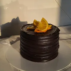 My Mandarin Chocolate cake is an absolute beauty. The dark, rich chocolate frosting is complemented by the bright, fresh orange slices on top.