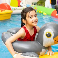 A happy memory from our last Splash Fiesta. This little swimmer is having a great time with her penguin floatie.