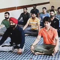 A group of students at the ARI Maritime College practicing a seated spinal twist. These outreach programs are an important part of our mission to make yoga accessible to everyone.