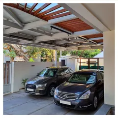 A view of the cantilevered steel and wood canopy for the car park of the residence. This structure is both functional and a key part of the building's modern aesthetic.