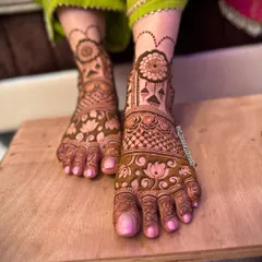A beautiful bridal foot design featuring lotus flowers and other traditional motifs. The pattern extends from the ankle to the toes for a complete look.