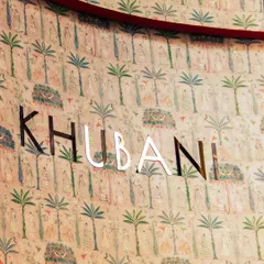 This close-up of our logo against the artistic wallpaper captures the essence of Khubani. Every corner is a canvas, with intricate motifs and cultural symphonies that create an ethereal and sophisticated interior.
