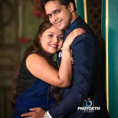 A warm and affectionate indoor portrait. The simple, loving hug and the couple's happy smiles make this a beautiful and timeless image.