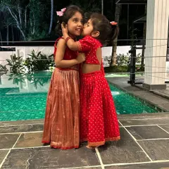 Sweet sibling moments. Little Kaanana and her sister in their custom red lehenga sets, perfect for a family wedding or festive celebration.
