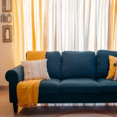 This is what it's all about: creating a space that feels uniquely you. I love how the bold teal sofa comes alive with our sunny yellow throw and layered sheer curtains, turning this living room into a warm, inviting, and vibrant home.