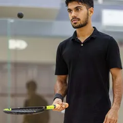 The calm before the storm. A squash player's intense concentration is palpable as he tracks the ball. I use lighting and focus to isolate the athlete, highlighting their mental game in the fast-paced environment of the glass court.