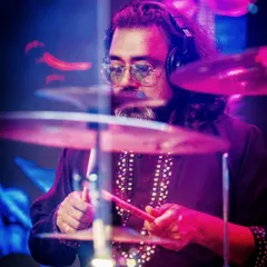 Our drummer, focused and precise, driving the rhythm of the band forward.