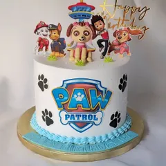 This Paw Patrol cake is ready for a ruff-ruff rescue! It's a non-fondant cake decorated with the Paw Patrol logo, paw prints, and all the main characters, including a fondant Skye topper.