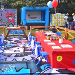 This activity zone at the Transformers party included an inflatable archery station, a giant connect-four game, and a craft table, ensuring a variety of entertainment options.