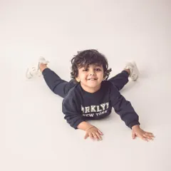 A playful, happy shot of this little boy on the floor. We let kids be kids, which results in the most genuine and joyful expressions.