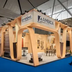 The design for Ambica's 110 sq.m exhibition stall was inspired by the rhythmic motion of a conveyor belt. We translated this industrial aesthetic into an elegant architectural form, with waves rippling around the fascia to suggest dynamic movement.