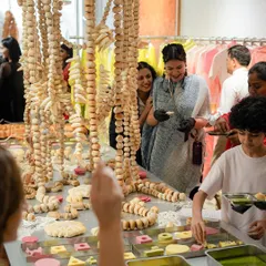 Guests interacting with our unique 'bread and butter' installation at a fashion store launch. The event was designed to be an immersive experience, where food became a form of wearable art.