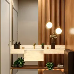 I used vertical wooden slats as an accent wall in this bathroom, adding texture and warmth. The pendant lights and marble countertop elevate the space, giving it a touch of modern luxury.