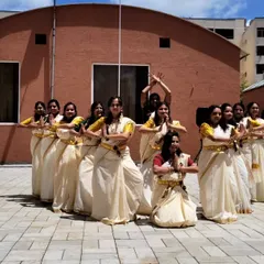 The beautiful formation of our Onam dance group, all dressed in traditional Kerala sarees. The visual harmony of the group was as important as the dance itself.