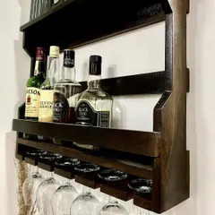 For your convenience, I have set up a mini-bar area with a wall-mounted rack for bottles and glassware, so you can enjoy your favorite drinks.