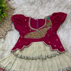 A close-up of the bodice, showing the intricate peacock embroidery with bead and stonework.