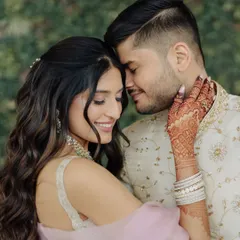 A beautiful, intimate moment from an engagement. Her pastel lehenga is paired with a soft glam makeup look, featuring a gentle shimmer on the eyes and a natural, glossy lip.