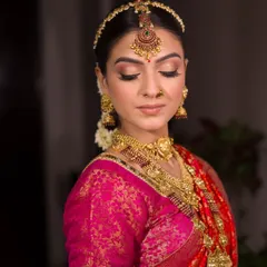 A close-up on the exquisite details of the eye makeup. A sharp, winged liner and golden shimmer on the lids are key elements of the classic South Indian bridal look.