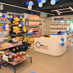 A wide-angle view of our newest multi-speciality pet hospital in Vastrapur, Ahmedabad. The bright, clean, and well-stocked environment includes a reception area, prescription food section, and a variety of pet products.