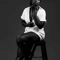 A powerful monochrome portrait that uses shadow and light to create a dramatic, soulful mood. This is an example of my work celebrating diverse beauty in a classic, honest style.