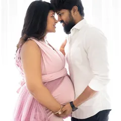 A beautiful and intimate close-up of an expecting couple, nose-to-nose, sharing a quiet moment of connection.