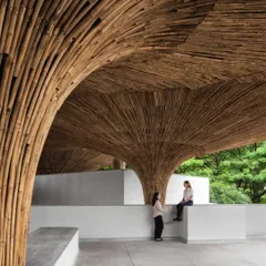 The shared spaces at the TAPMI Centre are defined by the organic forms of the bamboo parasols. These structures create a dialogue between the built environment and the natural landscape, fostering a sense of belonging.