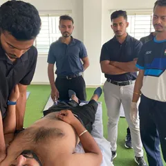 During a professional development session, I'm demonstrating a manual therapy technique for the shoulder complex. Hands-on skills are critical, and we constantly work to refine them across our entire team.