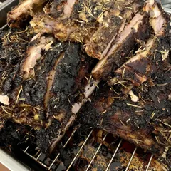 These are our rosemary-crusted pork ribs, resting after being slow-cooked. The process of cooking and resting renders out the flavorful fat, which we collect to make our infused lard.