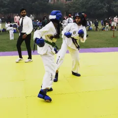 An intense moment during a sparring match between two of my female students. This is where training meets application, testing their reflexes and strategy in a competitive setting.