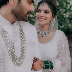 A beautiful moment between this couple. The bride wears a modern white lehenga with soft glam makeup, featuring smokey eyes and nude lips for an elegant finish.