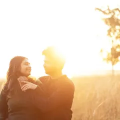 A tender embrace as the sun shines brightly behind them. This golden hour shot is filled with warmth and light, perfectly reflecting the love between the couple.