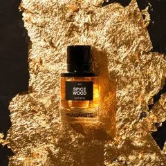 A luxury perfume shot with the bottle placed on a bed of gold leaf. This styling choice immediately communicates a sense of opulence and high value.