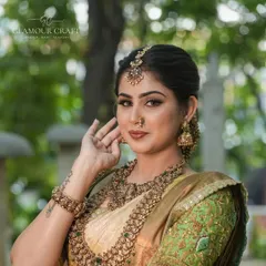 This is a classic bridal portrait showcasing our layered temple jewellery set. The combination of a choker and a longer kasina sara (coin necklace) creates a full and traditionally rich look.