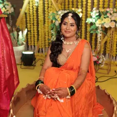 Our bubbly bride enjoying her Haldi ceremony. Her makeup is fresh and vibrant, designed to last through all the fun and festivities.