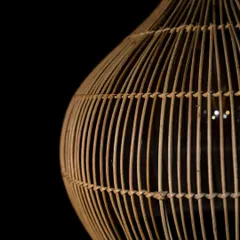 A detailed shot of the vertical and horizontal weave on the teardrop bamboo pendant. This meticulous handiwork ensures both durability and the beautiful diffusion of light.