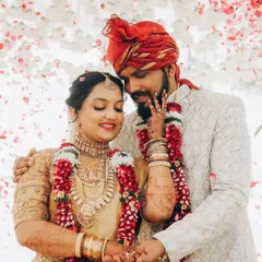 A magical moment for my bride Shreya and her groom. Her radiant smile and flawless makeup shine through the shower of petals.