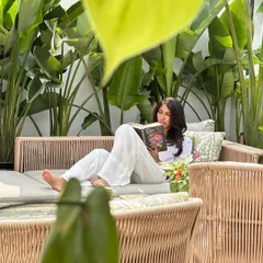 We believe spaces are about creating a calm, breathable environment. Here, a curated selection of tropical plants brings structure and softness to a modern outdoor seating area, perfect for relaxing with a book.