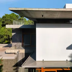 The sharp lines of the cantilevered concrete roofs create a powerful silhouette against the sky, demonstrating our focus on structural expression.