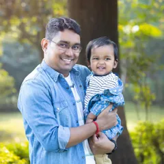 "Masti with Papa." A father holds his giggling son, both sharing a wide, happy smile. This candid shot perfectly captures the fun and playful side of their relationship.