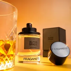 A sophisticated shot of 'Alpha Spade' perfume next to a glass of whiskey, with a digital sparkle added for a touch of magic. We can add subtle post-production effects to enhance the premium feel.