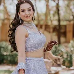 A beautiful client ready for her engagement. I styled her hair in a soft half-updo with voluminous waves, which looks romantic and elegant with her lavender lehenga.