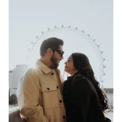 The iconic London Eye provides a perfect silhouette for this intimate couple portrait. The backlighting from the sun creates a beautiful flare, highlighting their connection as they gaze at each other.