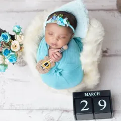 A tiny musician dreaming sweet melodies. Using miniature props like this guitar adds a unique and personal touch to your newborn's portraits.