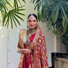 A candid moment captured during the wedding festivities. The makeup looks fresh and flawless even in natural outdoor lighting.